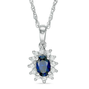 Oval Blue Sapphire and 0.18 CT. T.w. Diamond Starburst Frame Pendant